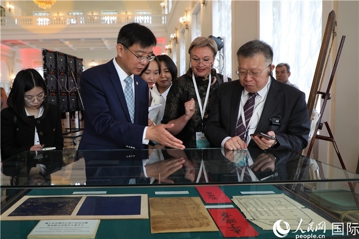 中俄圖書館論壇嘉賓共同參觀由俄羅斯國立列寧圖書館舉辦的館藏中國古籍善本圖書展。人民網(wǎng)記者 隋鑫攝）