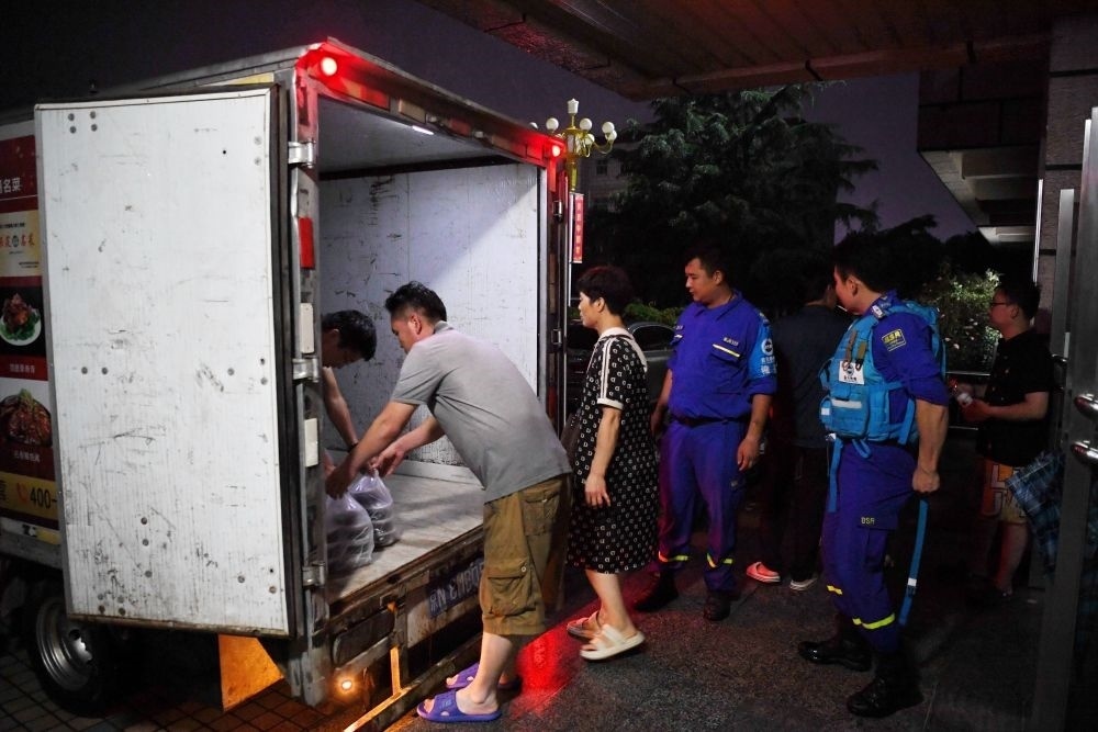 河北省涿州市職教中心安置點的工作人員在運送飯菜，準備發(fā)放給安置群眾（8月1日攝）。新華社記者 牟宇 攝
