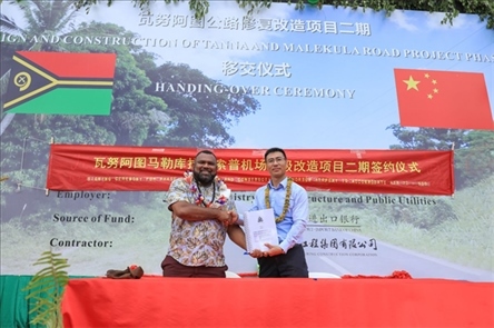 2023年12月18日，瓦努阿圖基礎(chǔ)設(shè)施和公共事業(yè)部長(zhǎng)瑞克·查馬克·馬赫（左）和中土南太公司總經(jīng)理梁慶（右）在馬勒庫(kù)拉諾索普機(jī)場(chǎng)升級(jí)改造二期項(xiàng)目的簽約儀式上握手。人民網(wǎng) 賀吉攝