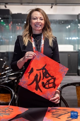 1月28日，在上海豫園舉行的民俗活動上，美國馬斯卡廷初中校長珍妮弗·李·弗里德利展示自己寫下的“?！弊帧?新華社記者 王翔 攝