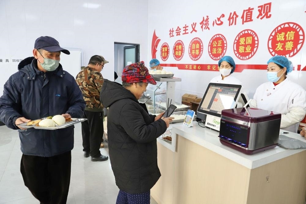 △2024年2月1日，市民在河北涿州市雙塔街道永濟(jì)秀園小區(qū)便民食堂內(nèi)購(gòu)買午餐。