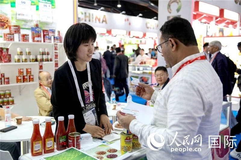 圖為中國(guó)參展企業(yè)代表與采購商交流。人民網(wǎng) 塔里克·易卜拉欣攝