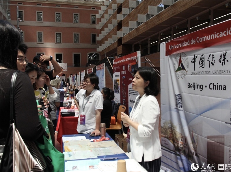 旅西華人華僑在展臺前咨詢。人民網(wǎng)記者 許海林?jǐn)z