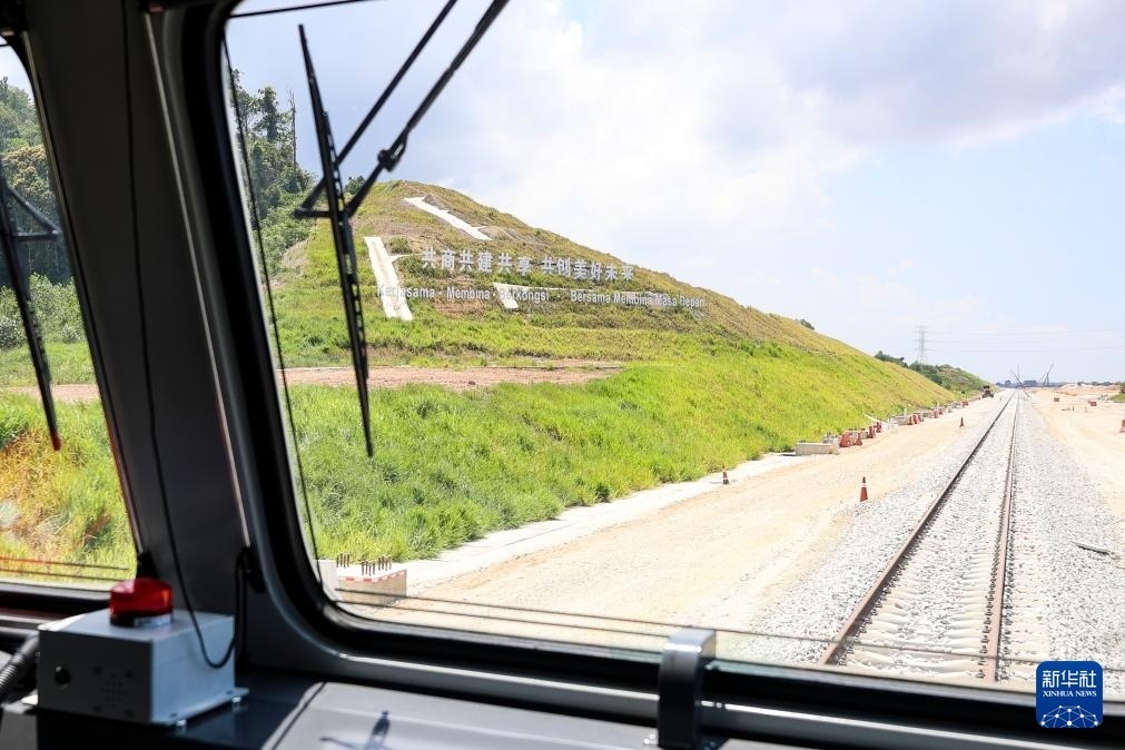 5月6日，在馬來西亞彭亨州馬東鐵項(xiàng)目沿途的山坡上，兩行中文和馬來文大字“共商共建共享，共創(chuàng)美好未來”映入眼簾。新華社記者 程一恒 攝