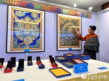 熱貢藝術(shù)國(guó)家級(jí)代表性傳承人夏吾角向嘉賓介紹作品。人民網(wǎng)記者 簡(jiǎn)承淵攝