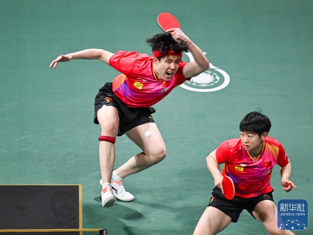 ↑中國(guó)隊(duì)組合王楚欽（左）/孫穎莎在混雙比賽中。新華社記者 王曦 攝