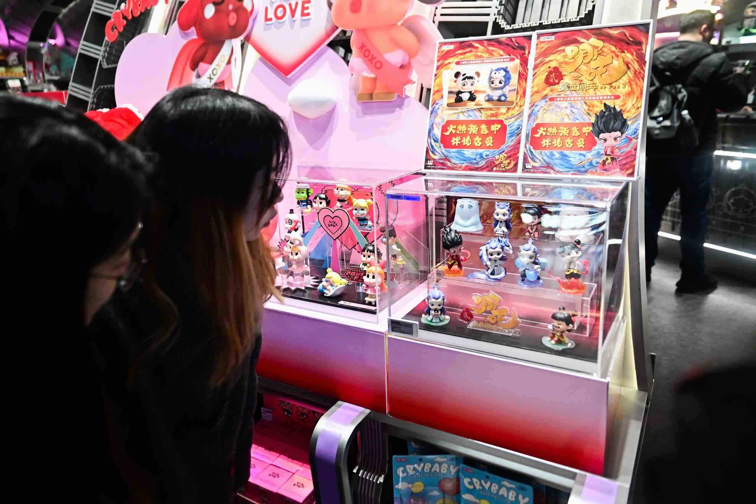 △2025年2月22日，上海，市民在圍觀《哪吒之魔童鬧?！废嚓P(guān)手辦盲盒。